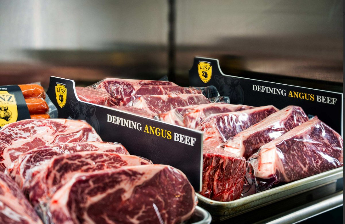 What To Know Before You Order Steaks Online Cuts of uncooked steak are individually packed in plastic wrap and sit on metal trays in a display case.